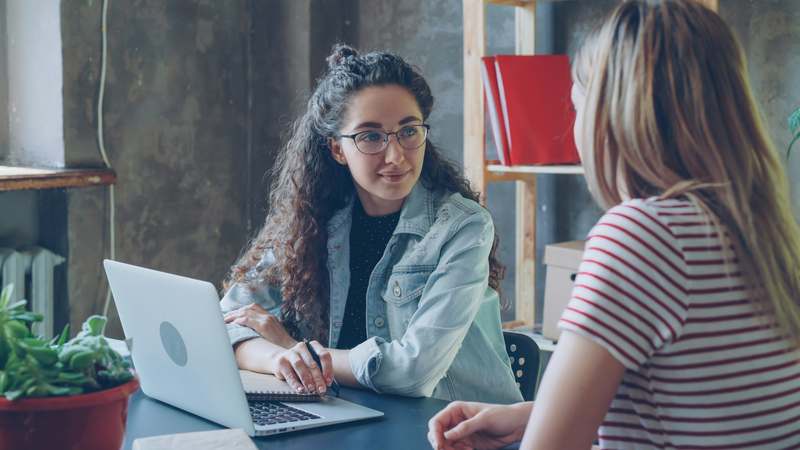Diverse group of professionals collaborating during a mock interview session in a bright office space